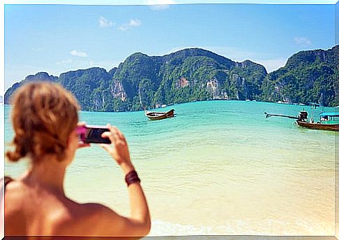 Woman photographing a beach