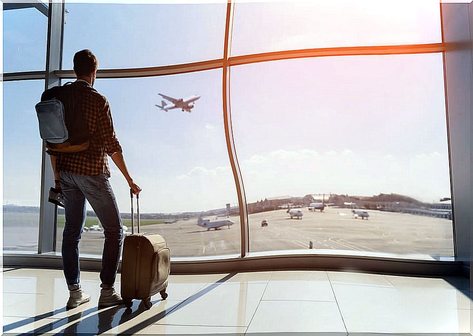 Traveler at an airport thinking about intensive or extensive travel