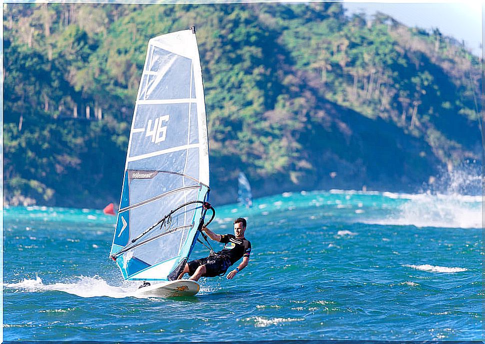 Young man windsurfing on Boracay Island.