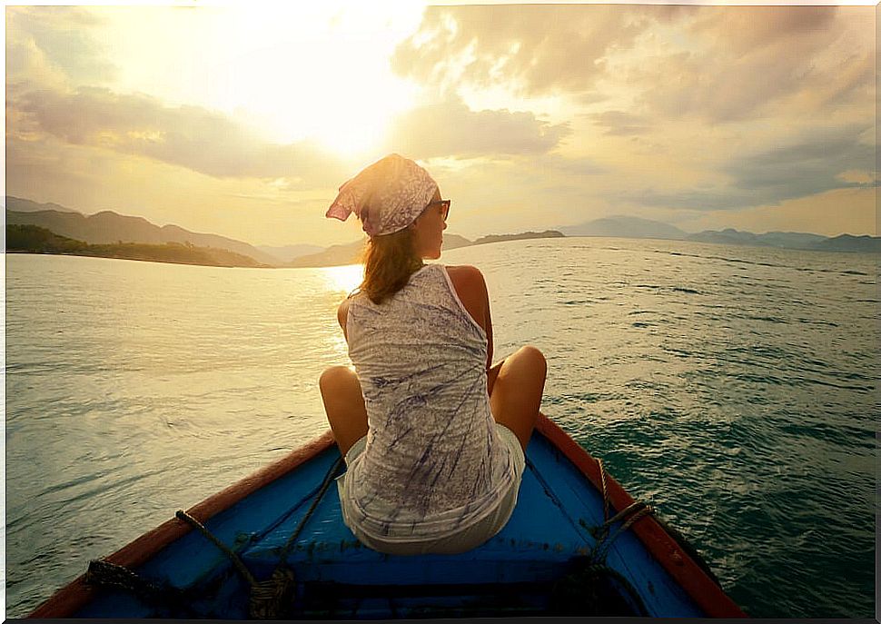 Woman watching the sunset in a boat